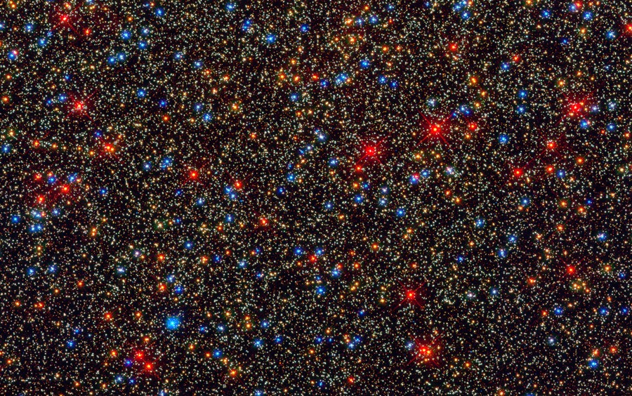 Thousands of stars are seen grouped close together.