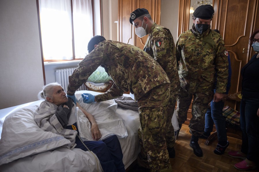 A woman receives a vaccine dose in her home.