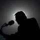 Silhouette of Donald Trump speaking into a microphone