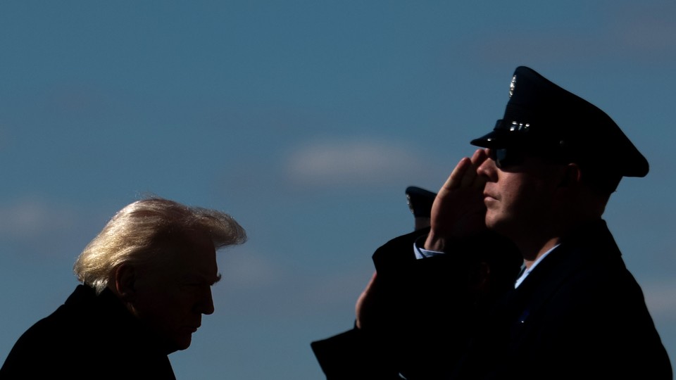 An image of America military personnel saluting President Trump.