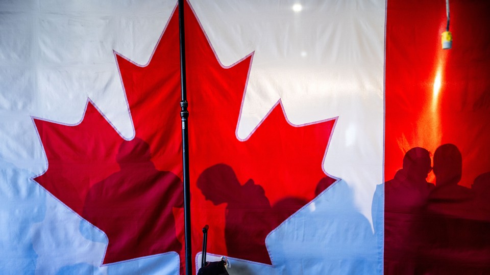 A photo featuring a Canadian flag's red-maple symbol.