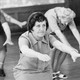 B&W photo of older women exercising in a large room