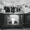 Customers in the electronics section of a department store watch as JFK addresses the nation