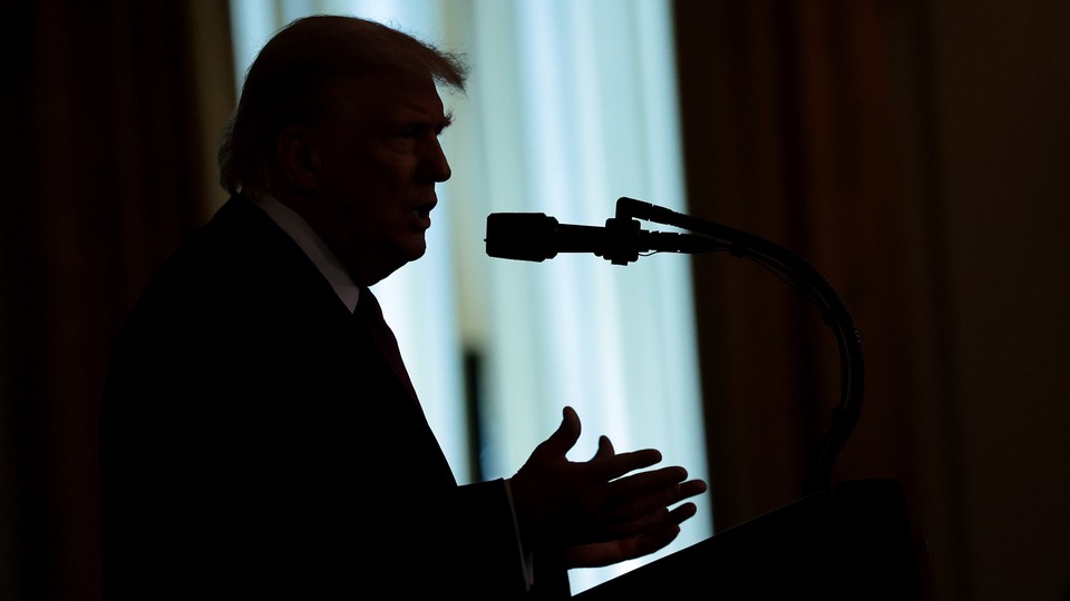 Donald Trump speaking into a microphone