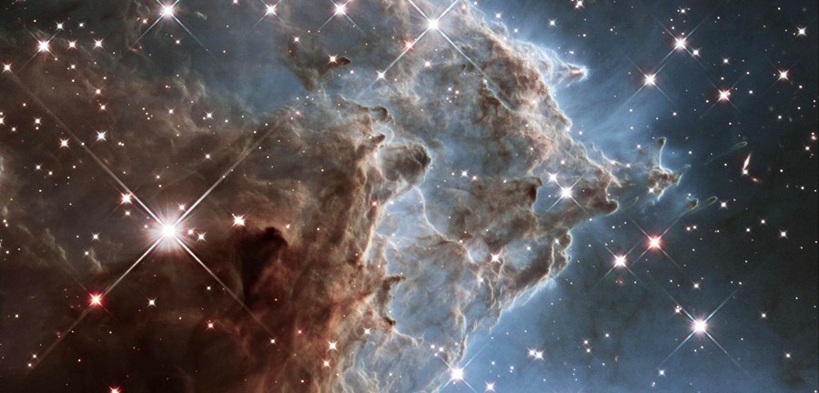 A massive cloud of gas and dust billowing in space among many stars