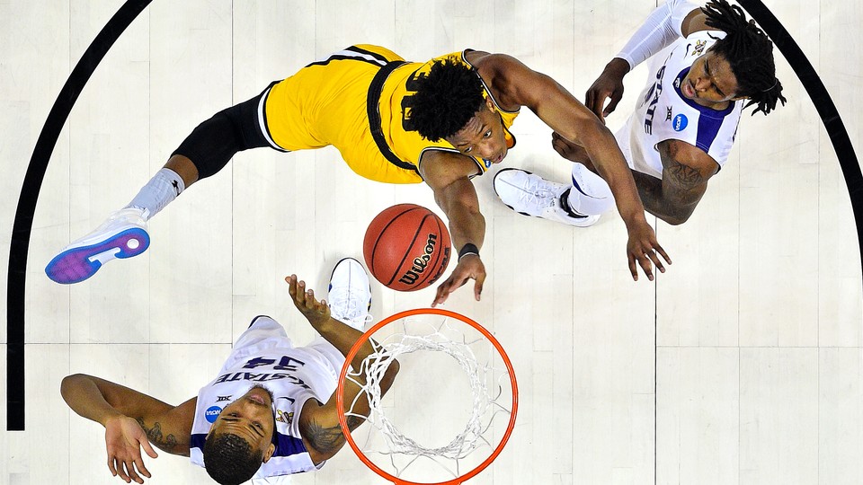 The UMBC Retrievers forward Daniel Akin (30) shoots the ball against Kansas State Wildcats forward Levi Stockard III (34) during the first half in the second round of the 2018 NCAA Tournament at Spectrum Center