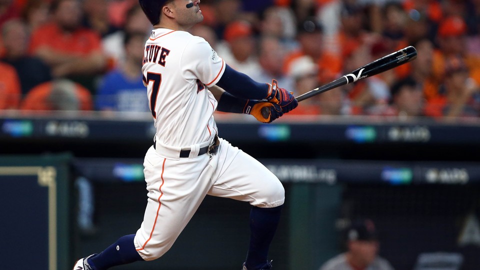 The Houston Astros second baseman Jose Altuve hits a solo home run during the fifth inning against the Boston Red Sox in game one of the 2017 ALDS playoff baseball series at Minute Maid Park.