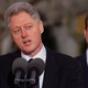 Bill Clinton speaking with Al Gore in the background