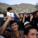 Young Afghan men and women listen to a concert in Kabul.