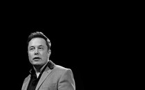 A photo of Elon Musk with a black background