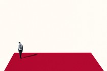 A man walks alone on a red platform