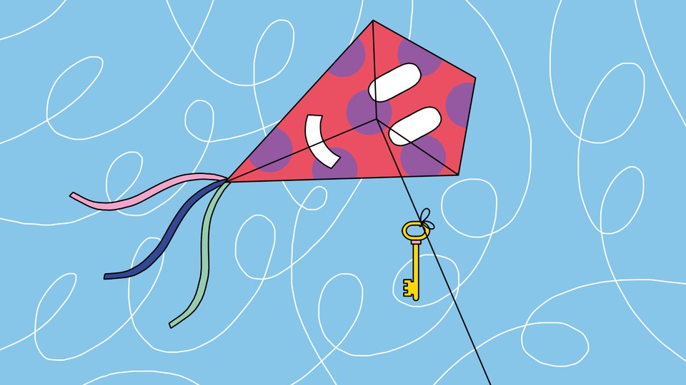A kite with a smiley-face decoration and a key tied to its string