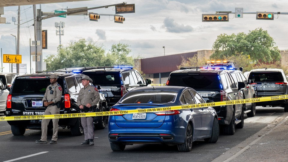 Law-enforcement vehicles and officers gathered at the scene of a shooting in Austin, Texas