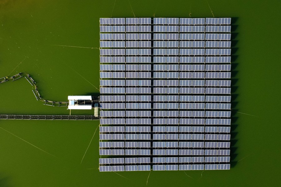 An aerial view of a raft of floating solar panels.