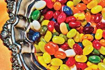 a close up of a silver dish full of colorful jelly beans