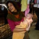 After fleeing from Burma, Noor Kayes holds her daughter in a refugee camp in Cox’s Bazar, Bangladesh, February 9, 2017.