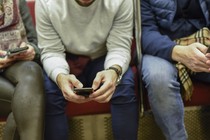 Person on their phone on the subway