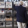 A man picks up a newspaper reporting on the outcome of the U.K.’s general election in London on June 10, 2017. 