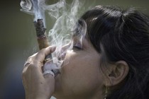 Cigar sommelier Ivonne de La Puente, 47, smokes a cigar during the XVII Habanos Festival in Havana, February 23, 2015.