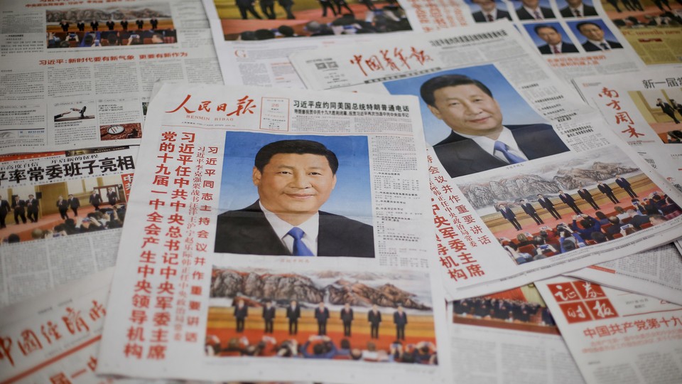 Newspapers with photos of Xi Jinping