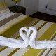 Two towels in the shape of swans on a bed
