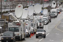 Television satellite trucks line an Oregon roadway near the scene of a mall shooting in 2012.