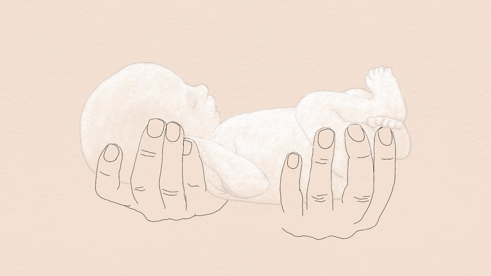 Two hands holding a translucent baby