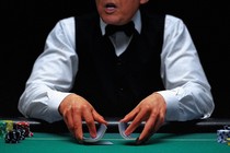 Trump is shown as a dealer at a casino, shuffling cards with chips piled on either side of him.