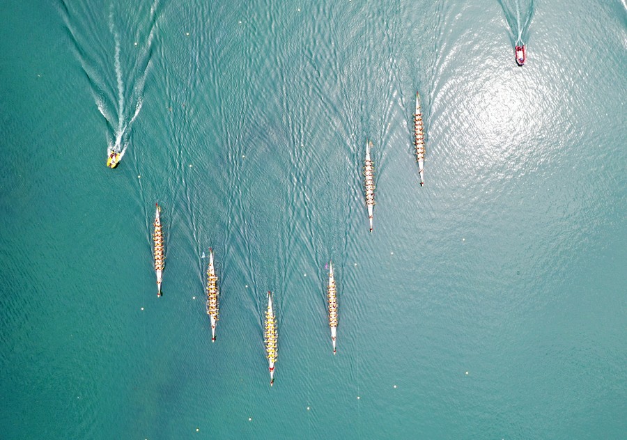 An aerial view of six dragon boats racing