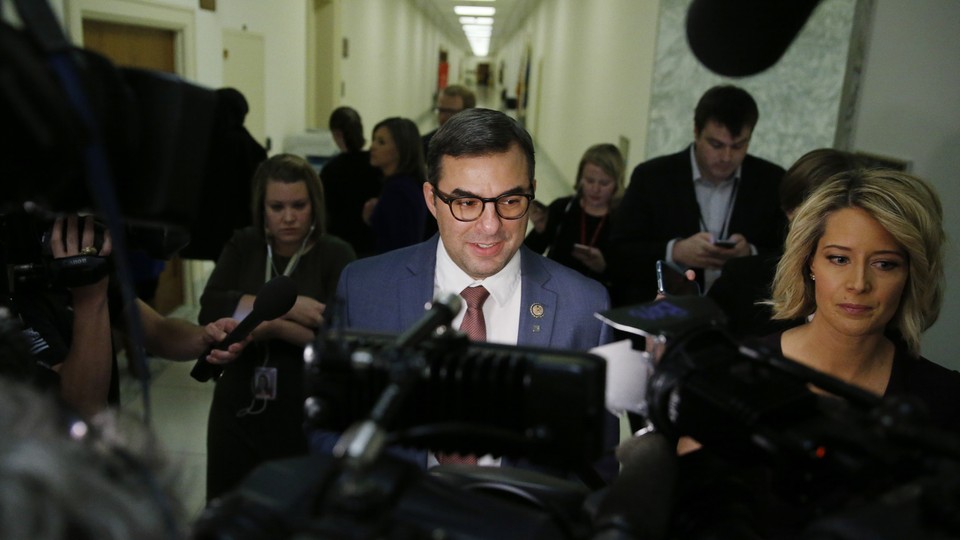 Representative Justin Amash of Michigan speaks to a throng of reporters.
