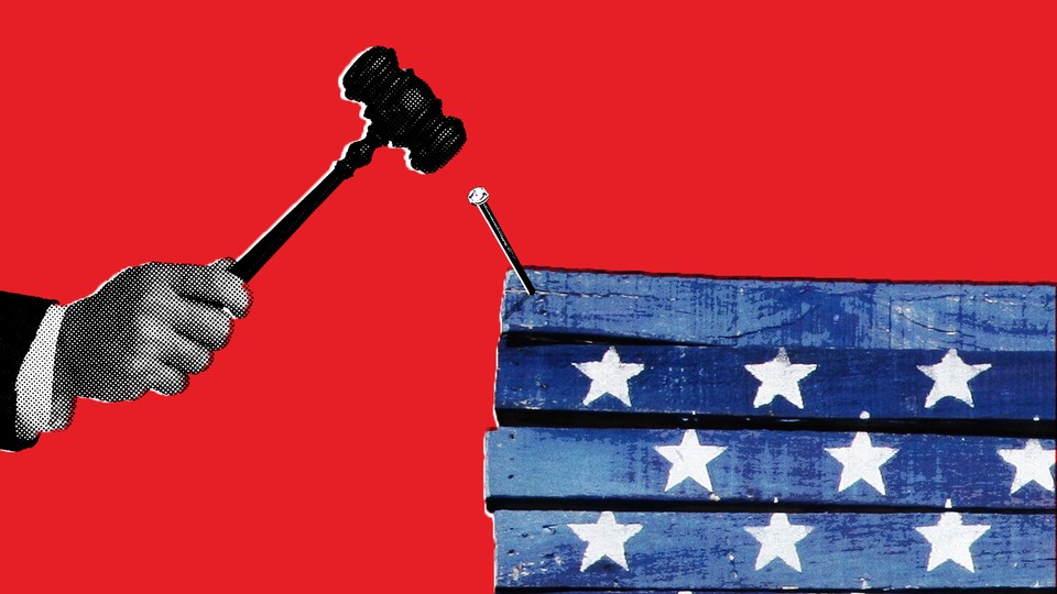 A gavel hammering a nail into some star-spangled boards