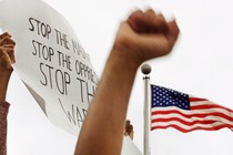 Protesters raising fists and signs