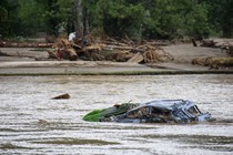 A destroyed car floats in floodwaters in Chimney Rock, North Carolina, in the aftermath of Hurricane Helene.