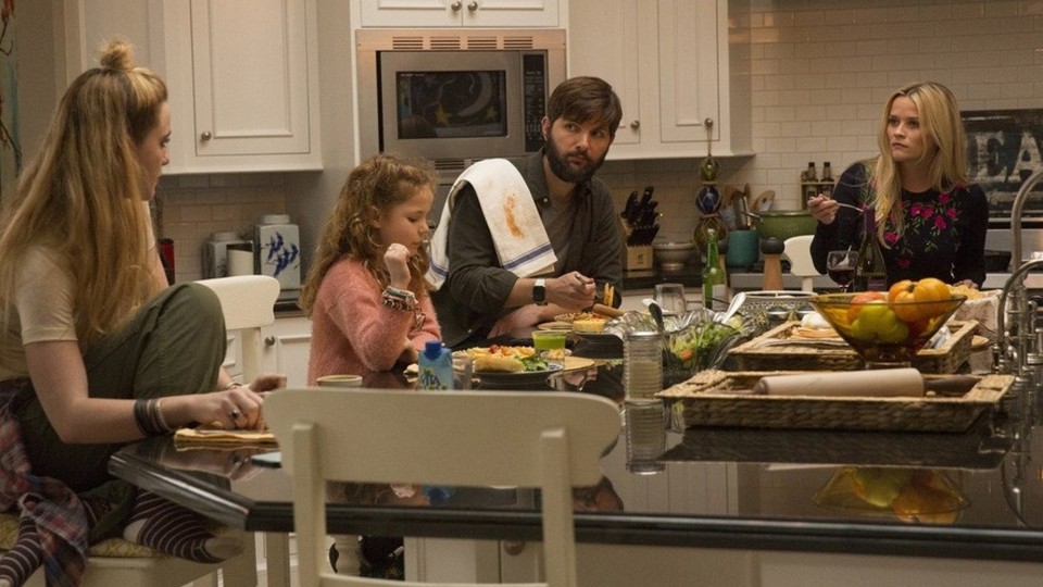 A screenshot of "Big Little Lies" featuring the actress Reese Witherspoon and her characters' husband and children.
