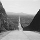 In a black-and-white photo, the long road between the United States and the Mexico border
