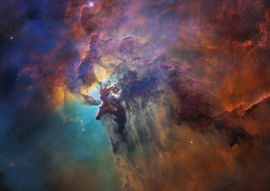 Multicolored swirling clouds of gas are seen in space.