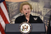 Madeleine Albright stands at a Department of State podium. 