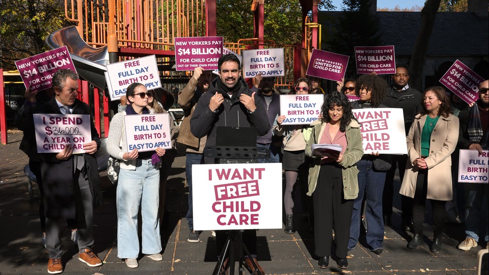 An image of Zohran Mamdani campaigning with signs promoting free child care