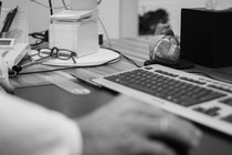 Black-and-white photo of someone at a desk