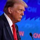 Donald Trump stands in front of a microphone during CNN's presidential debate
