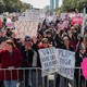 People hold signs during a rally and march at Grant Park on October 13, 2018, in Chicago, Illinois to inspire voter turnout ahead of midterm polls in the United States