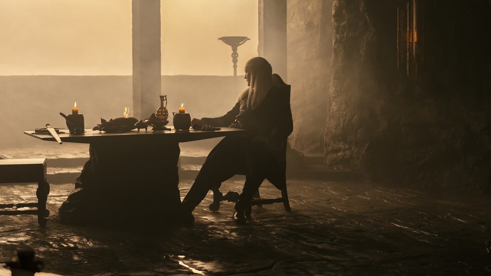 Matt Smith sitting at a table in a gloomy castle in "House of the Dragon"