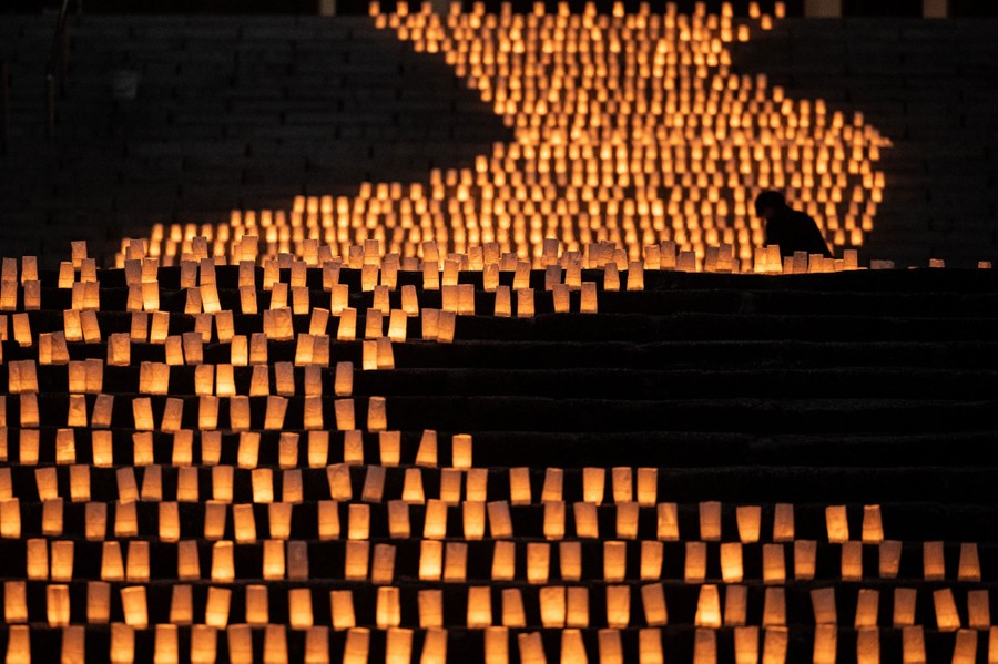 Thousands of candles are arranged on a broad staircase.