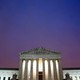 The Supreme Court building in front of a purplish-blue sky