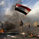Protester waving Iraq flag after missile strike in Baghdad