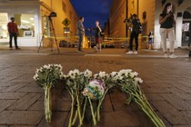 Flowers and other mementos are left at a makeshift memorial for the victims after a car plowed into a crowd of people protesting in Charlottesville, Virginia.
