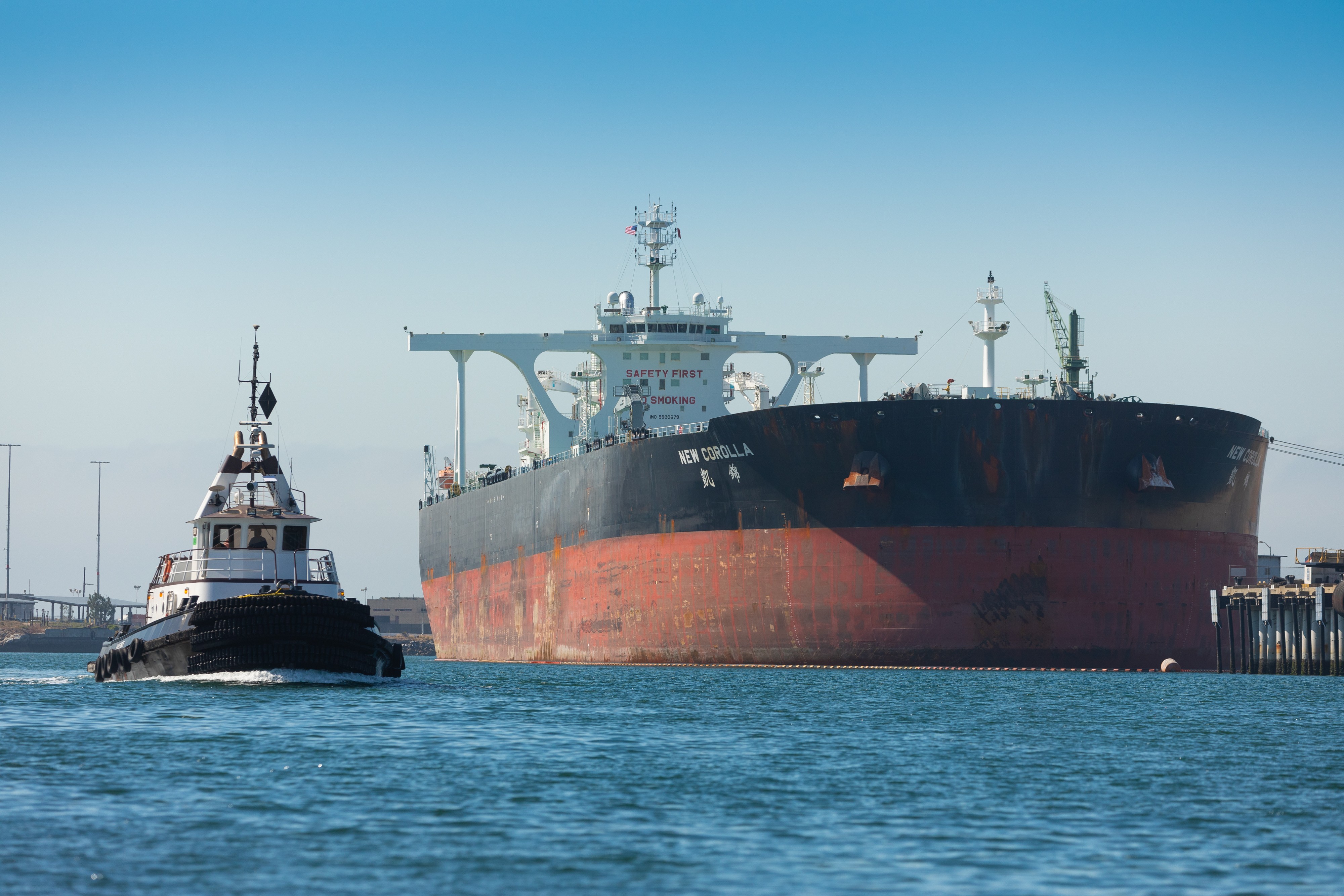 An oil tanker, docked at a terminal
