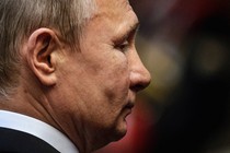 A close-up photo of Vladimir Putin's face seen from the right