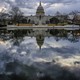 The Capitol is reflected in a pool in front of the building.