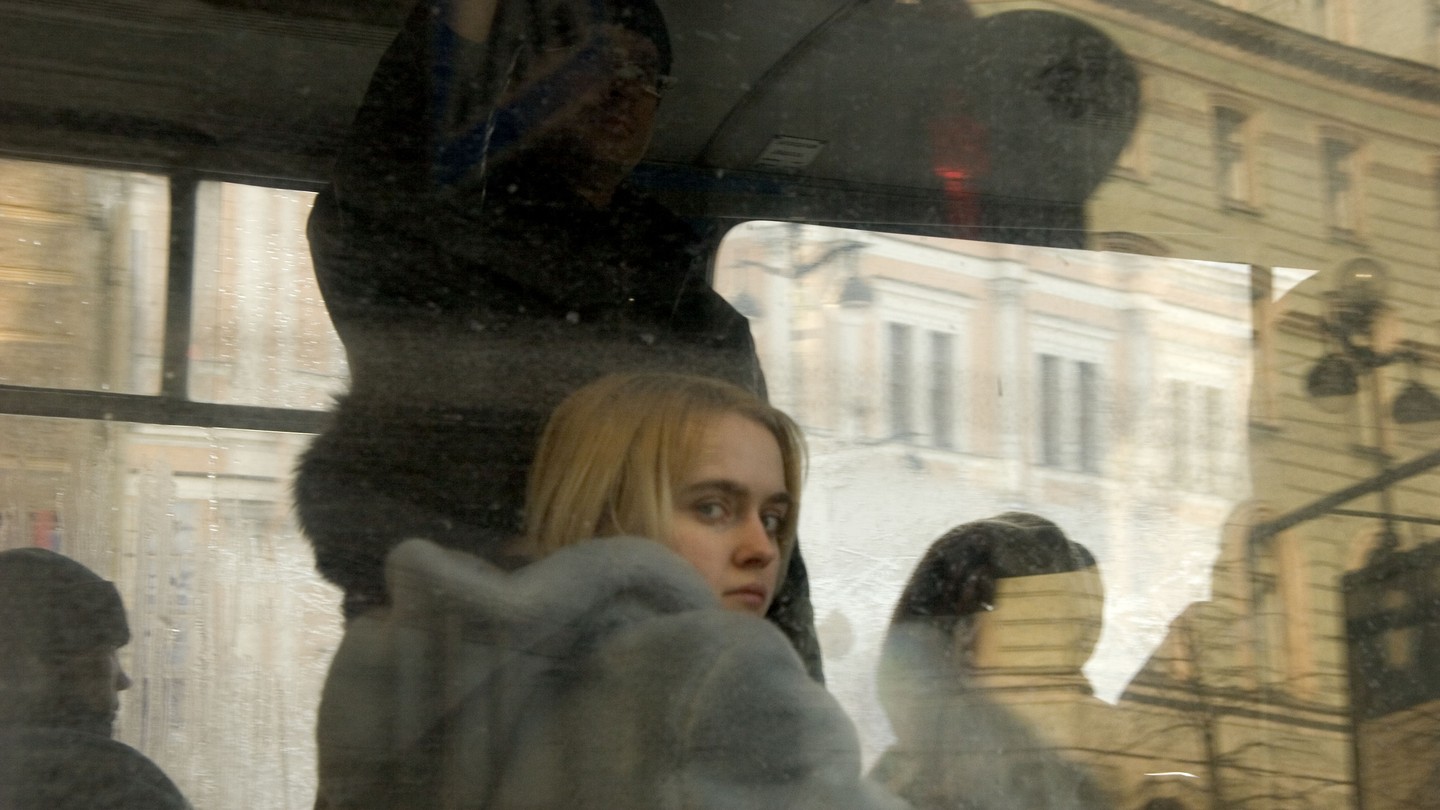 A young woman looks out a bus window in St. Petersburg, Russia.